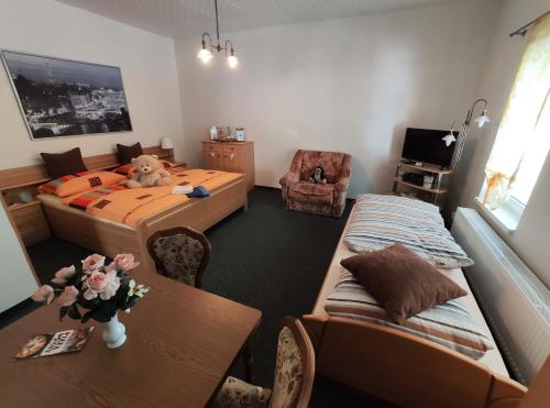 a bedroom with a bed and a table and chairs at Penzion u Krtka in Kraslice