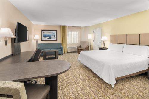 a large hotel room with a large bed and a couch at Candlewood Suites Destin-Sandestin Area by IHG in Destin