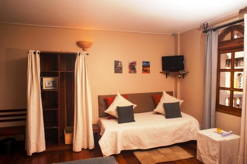 a bedroom with a bed with pillows on it at Les 3 Métis in Antananarivo