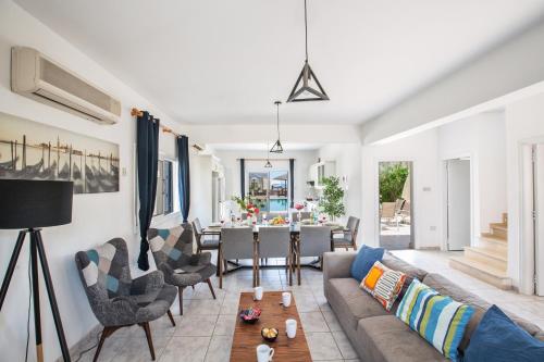 a living room with a couch and a table at Jason Villas in Protaras