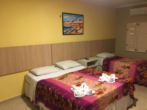 Una cama o camas en una habitación de Hotel Pousada Latitude