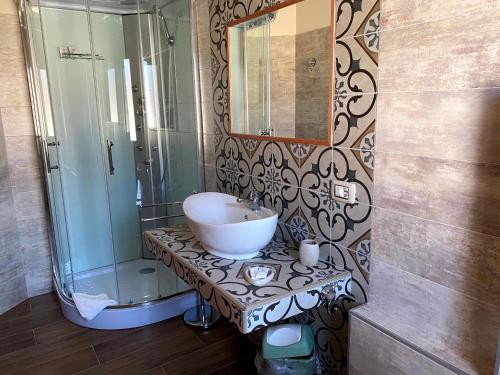 a bathroom with a sink and a shower at Janas B&B in Posada