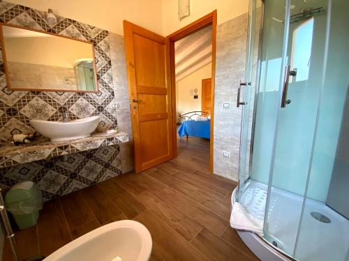 a bathroom with a toilet and a sink and a shower at Janas B&B in Posada