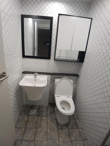 a bathroom with a toilet and a sink and a mirror at Yong Stay in Jeju