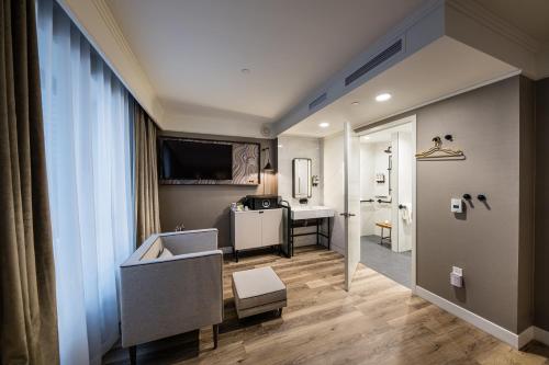 a living room with a couch and a table at Pestana Park Avenue in New York