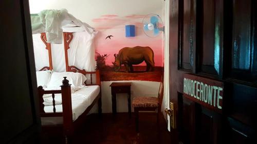 a bedroom with an elephant painted on the wall at Boutique Hotel Nyumbani Tembo in Watamu