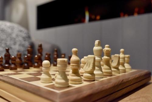a chess board with white chess pieces on a table at Staybridge Suites - Dundee by IHG in Dundee