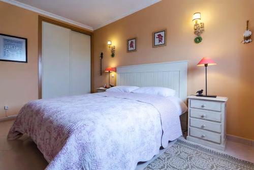 ein Schlafzimmer mit einem großen weißen Bett und einer Kommode in der Unterkunft Seaview at Vila da Praia in Alvor