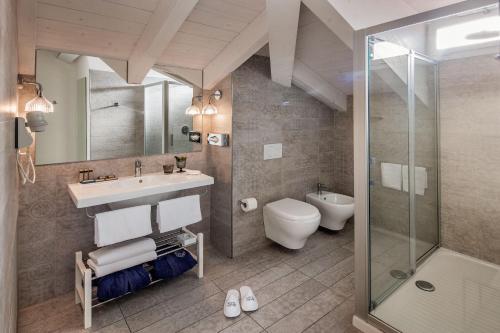 a bathroom with a sink and a toilet and a shower at Hotel Lido in Alassio