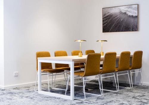 a dining room with a white table and chairs at Quest Robina in Gold Coast