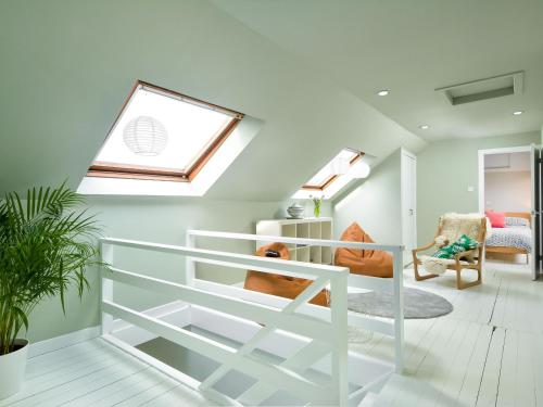 a living room with a skylight and a white staircase at Borgan Cottage in Newton Stewart