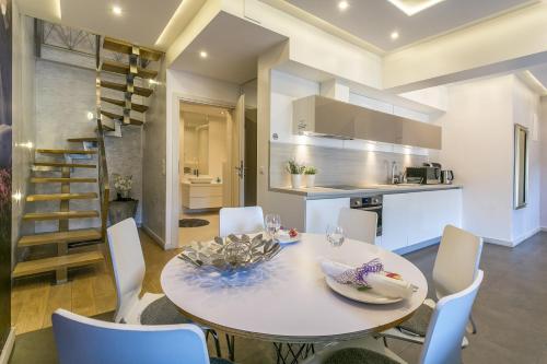 a kitchen and dining room with a white table and chairs at VIP Apartamenty Stara Polana in Zakopane