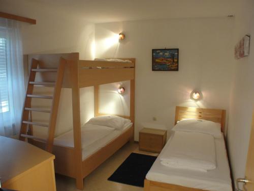 a bedroom with two bunk beds and a ladder at Apartment St. Nikola in Sankt Nikola an der Donau