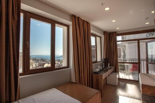 a hotel room with a bed and large windows at West Palace in Istanbul