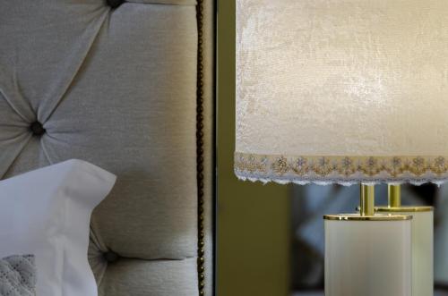 a lamp sitting next to a bed with a pillow at Hotel Alvorada in Estoril