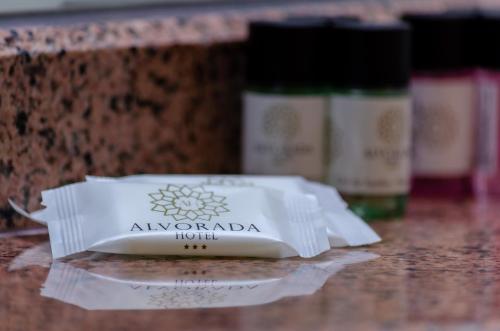 a bottle of alveraolin sitting on a counter with two bottles at Hotel Alvorada in Estoril