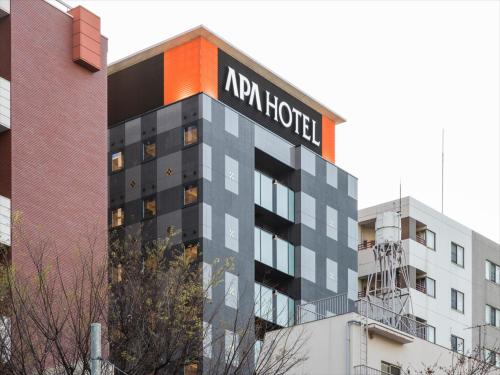 a building with a hotel sign on top of it at APA Hotel Ningyocho-eki Higashi in Tokyo