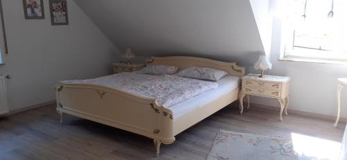 a bedroom with a bed and two night stands at Ferienwohnung Mai in Gittelde