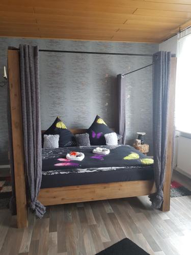 a bed with a canopy in a room at Ferienwohnung Talblume in Marl