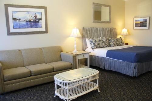 a hotel room with a bed and a couch at Surf Side Hotel in Nags Head