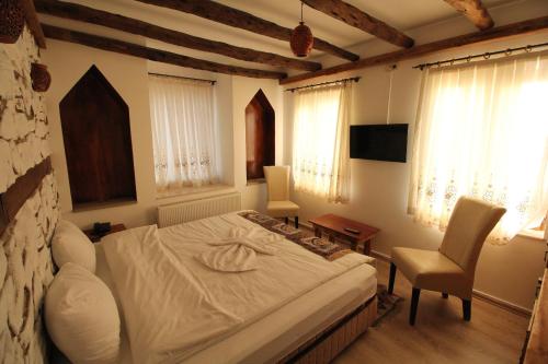 Ένα ή περισσότερα κρεβάτια σε δωμάτιο στο Kapadokya Konak