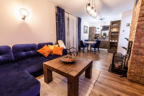 a living room with a blue couch and a table at Górski szafir in Jaworki