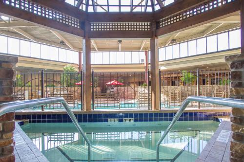 a swimming pool in a building with a pool at Holiday Inn Bloomington Airport, an IHG Hotel in Bloomington