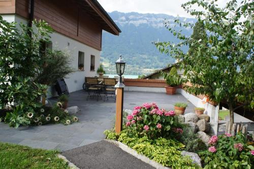 a patio with a light pole and some flowers at Sam & Cindy Mühlemann in Interlaken