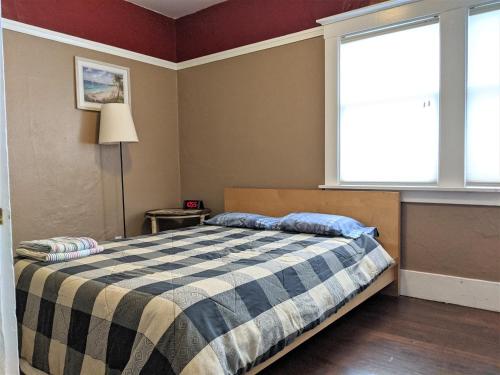 a bedroom with a bed and a large window at Relax in unpretentious peaceful and authentic house with public transportation cafes and U of Berkeley close by in Albany
