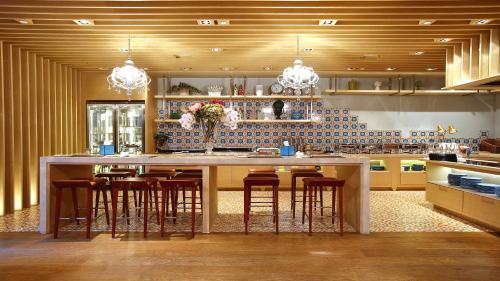 a kitchen with a large island with bar stools at Hotel Indigo Hong Kong Island by IHG in Hong Kong