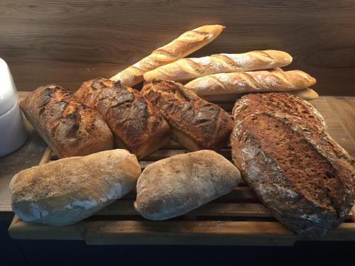 a bunch of different types of bread on a cutting board at Pension Haus Fürstenberg in Grünhain-Beierfeld