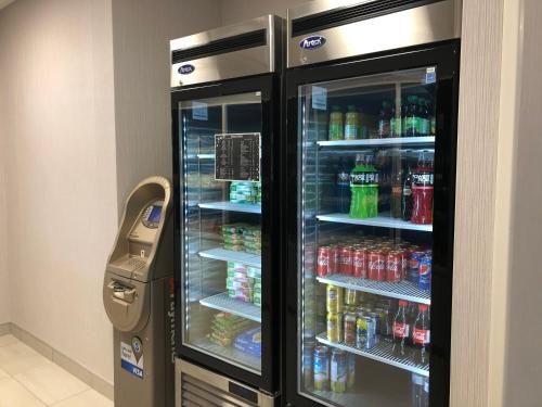 a refrigerator with soda and drinks in it at Holiday Inn Express & Suites Halifax Airport by IHG in Enfield
