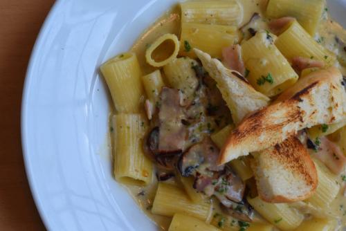 a plate of food with pasta with fish and meat at Summit Rainforest Golf Resort & All Inclusive in Paraíso