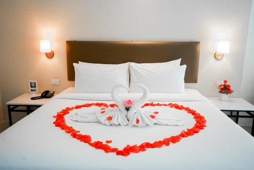 a bed with a heart made out of roses at Summer Tree Hotel in Bangna