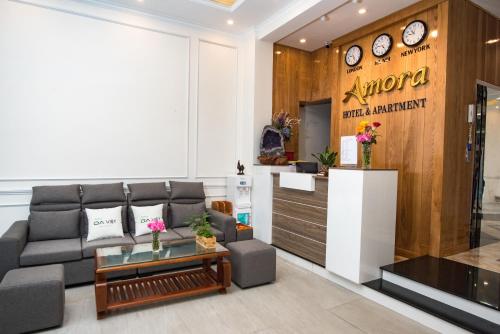 a living room with a couch and a counter at Amora Hotel & Apartment in Vung Tau
