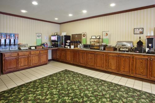 a coffee shop with wooden cabinets and a cash register at Country Inn & Suites by Radisson, Hiram, GA in Hiram