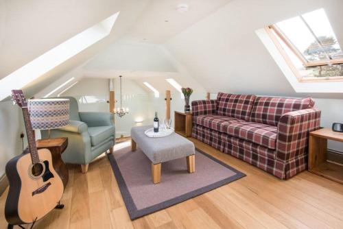 a living room with a guitar and a couch at Time in Galashiels