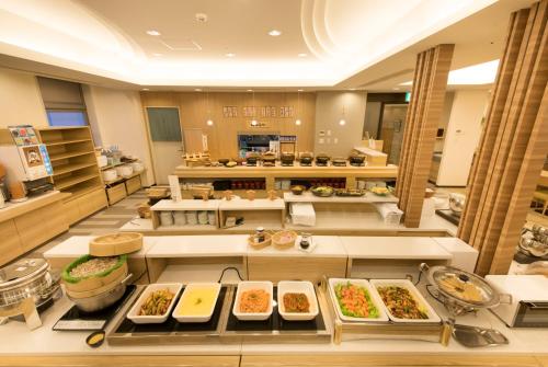 a kitchen filled with lots of different types of food at Richmond Hotel Yamagata Ekimae in Yamagata