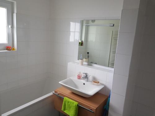 a white bathroom with a sink and a bath tub at Holiday House Tereza in Lipno nad Vltavou