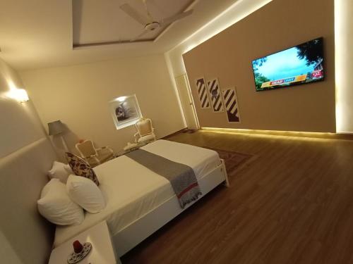 a hotel room with a bed and a flat screen tv at Hilton Bayview lnn in Karachi