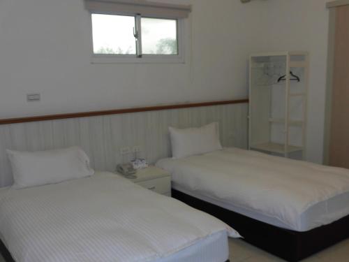 Postel nebo postele na pokoji v ubytování Shiang Ching Home Stay
