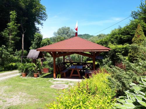 a gazebo with a flag on top of it at Chata z bali in Sucha Beskidzka