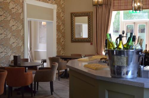 a bar in a restaurant with bottles of wine at St Andrews Town Hotel in Droitwich