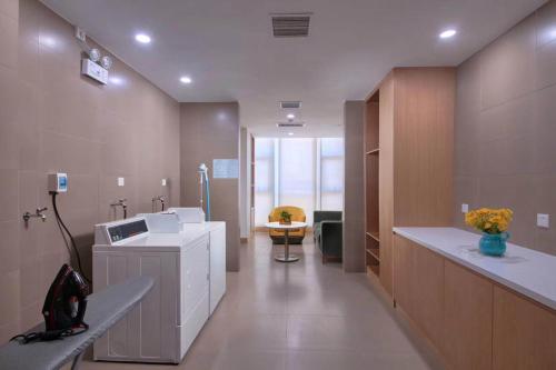 a hospital room with a washing machine and a sink at Holiday Inn Express Litang by IHG in Lithang