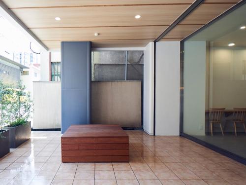 a wooden bench sitting in the middle of a lobby at You Style Hotel MARINE in Kagoshima