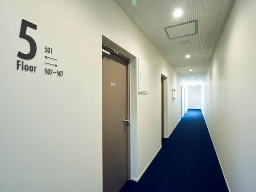 a hallway of an office with a floor sign on the wall at You Style Hotel MARINE in Kagoshima