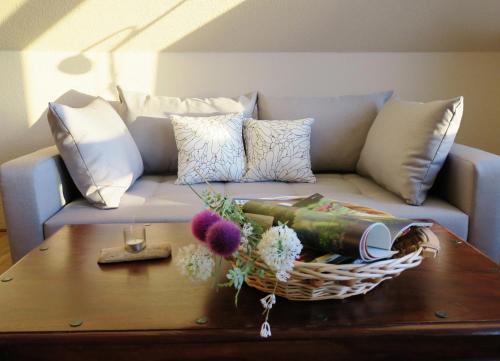 a couch with pillows and a basket on a coffee table at Casita in Apensen
