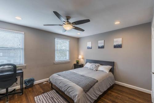 a bedroom with a bed and a ceiling fan at Beautiful 3br 2ba House with cozy backyard by CozySuites in Alexandria