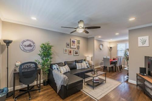 a living room with a couch and a ceiling fan at Beautiful 3br 2ba House with cozy backyard by CozySuites in Alexandria