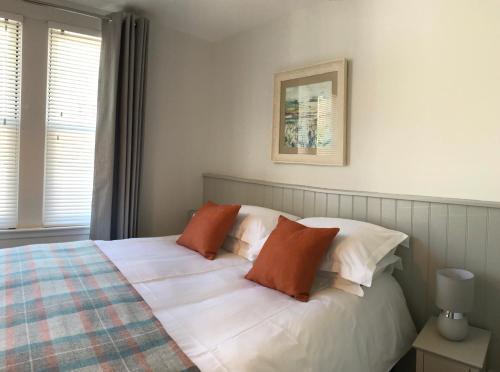 a bedroom with a bed with two pillows on it at 3 Argyle Place in Dornoch